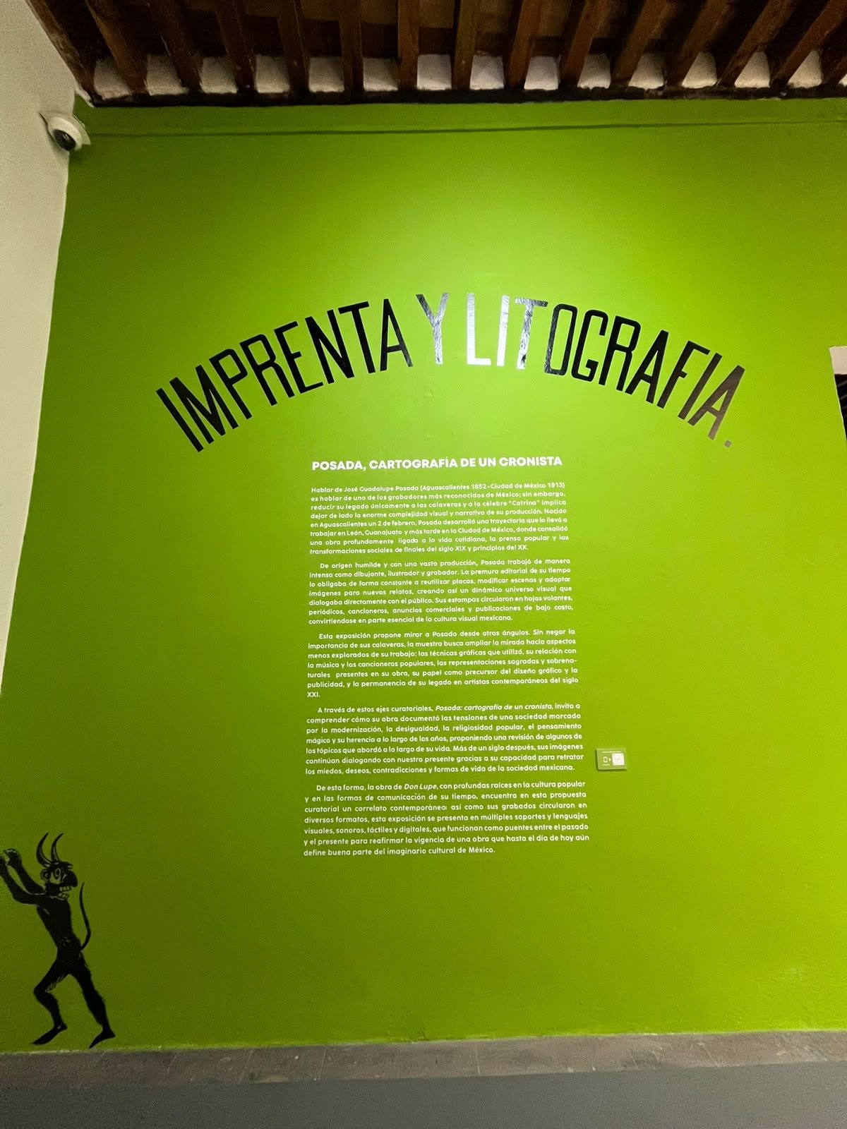 Muro verde de la sala Imprenta y Litografía con el texto curatorial de Posada. Cartografía de un cronista en el Munae