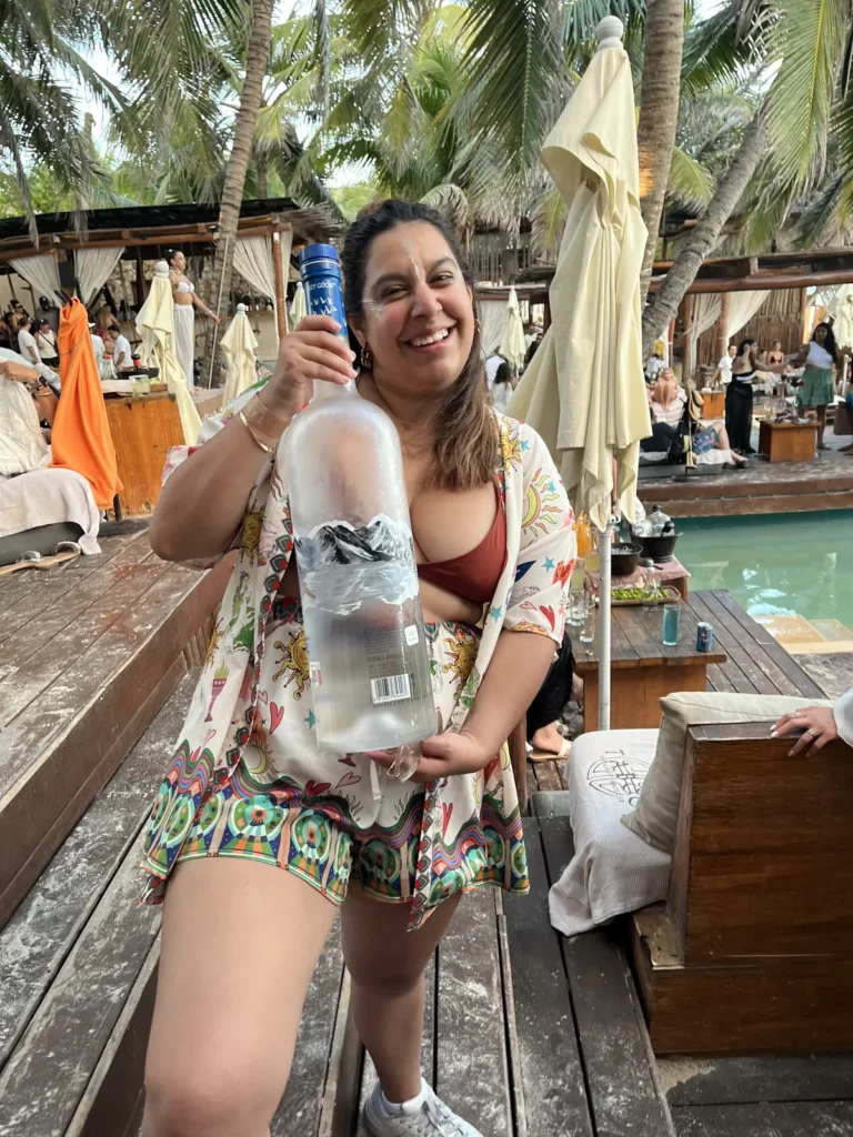 Terraza de madera de un club de playa con camastros y sombrillas en la zona hotelera de Tulum
